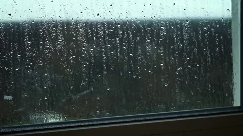 Raindrops Flow Down the Window Glass in Cloudy Weather Stock Footage 263759504
