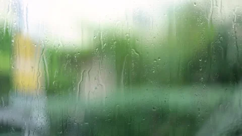 Raindrops Flow Down The Window, Greenery Blurred Background, Close-Up Shot Stock Footage 292313356