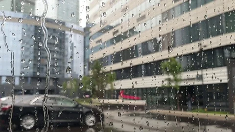 Raindrops flow through the glass window. bad weather in the city. Stock Footage 112284648