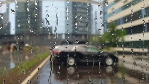 Raindrops flow through the glass window. bad weather in the city. Stock Footage 112284660