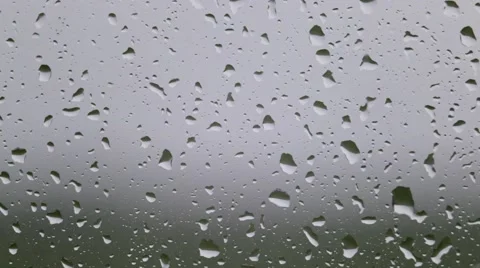Raindrops flow on the window glass Stock Footage 64070677