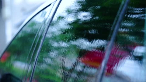 Raindrops Flowing Down a Car Window During a Heavy Rainstorm in the City Stock Footage 341999812