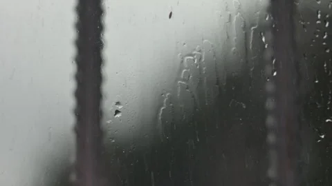Raindrops Flowing Down Window Glass During a Dark and Stormy Weather Day 스톡 동영상 339629560
