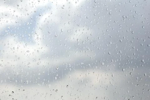 Raindrops flowing down on window glass abstract Stock Photos