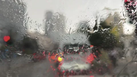 Raindrops flowing on a windshield during a rainy day in the city Stock-Footage 311403339