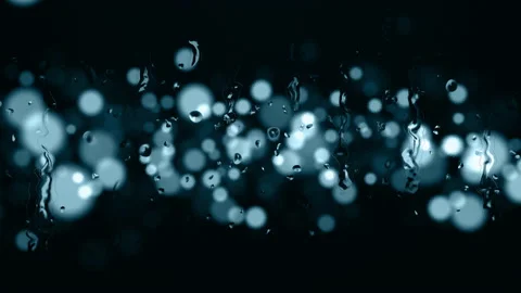 Raindrops following down on a glass background with light bokeh. Stock Footage 153728807