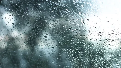 Raindrops getting down the window during a moody weather. Time lapse 4K Video stock 145915989
