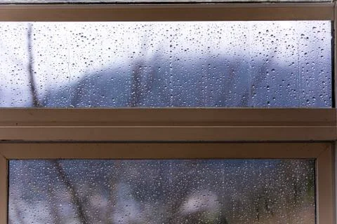 Raindrops on glass with blur background Stock Photos