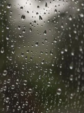 Raindrops on glass with blurred background creating abstract wet textures s.. 写真素材