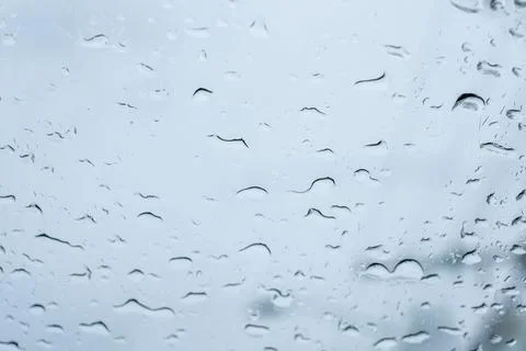 Raindrops on glass with blurred background Stock Photos
