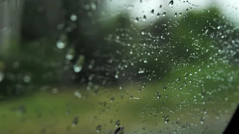 Raindrops on the glass of a car window while driving. Stock Footage 199139373