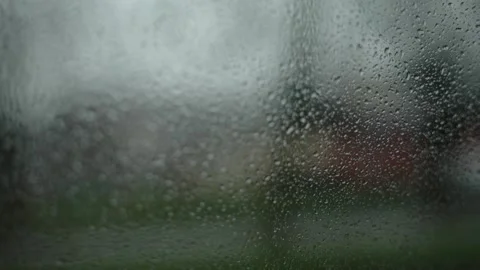 Raindrops on glass of car window while driving. First-person view passenger Stock Footage 323374414