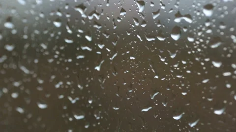 Raindrops on glass in closeup Stock Footage 102850259