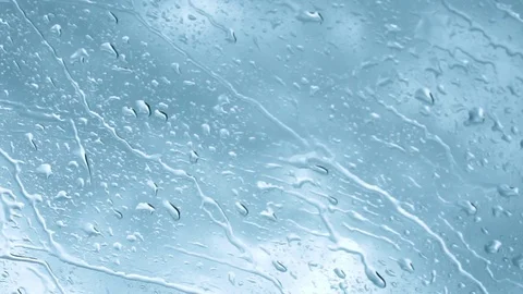 Raindrops on glass with a cloudybackdrop Stock Footage 116707552