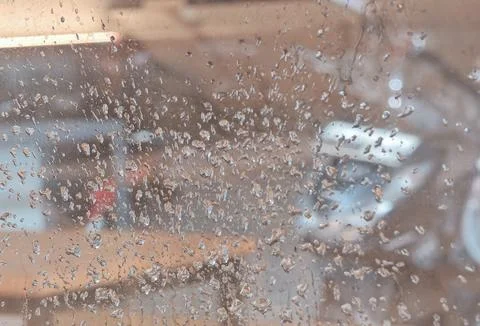 Raindrops on Glass Creating Abstract Blurred Background Texture Foto stock