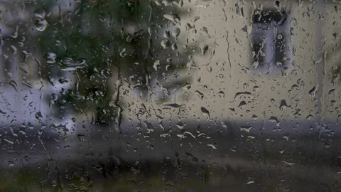 Raindrops on the glass. Drops flow down the glass closeup. 4k Stock Footage 116501596
