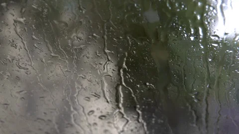 Raindrops on the glass. Drops flow down the glass closeup. 4k Stock Footage 116501786