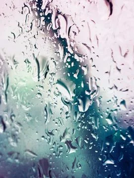 Raindrops on glass. Flowing drops of water. Selective focus. Stock Photos