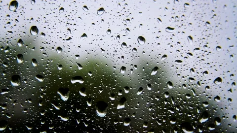 Raindrops on the glass. It's raining outside. Drops flow down the glass. Stock Footage 208131520