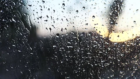 Raindrops on Glass with Sunset Glow Background Stock Footage 327107330