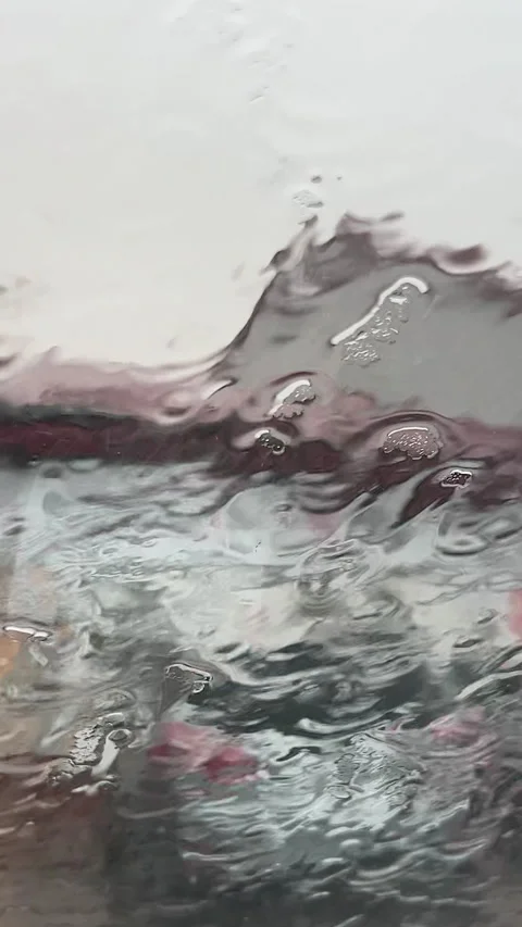 Raindrops On Glass Surface With Blurred Urban Background Vertical Stock Footage 340903561