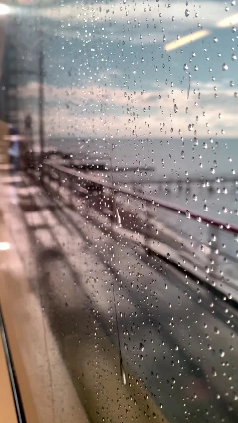 Raindrops on the glass of the train window in the morning. Moving forward Stock Footage 147322152