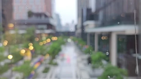 Raindrops on glass window with blurred view of city street Stock Footage 313149031