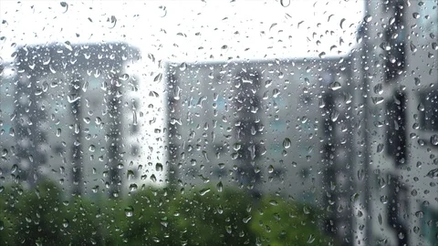 Raindrops on glass window with blurry condominium background Stock Footage 111811673
