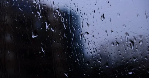 Raindrops on glass window closeup with dark background and high contrast Stock Footage 118276079