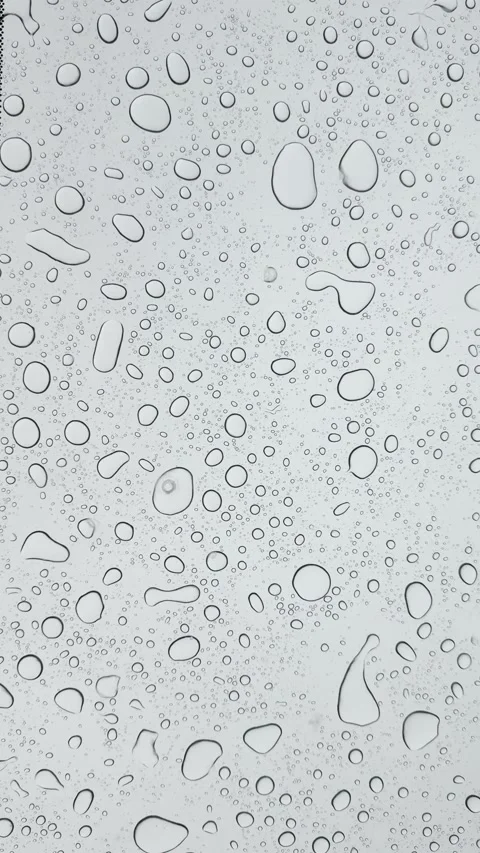 Raindrops on Glass Window Creating Soft Abstract Texture...1 Video stock 325333139