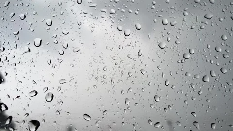 Raindrops on Glass Window with Moody Grey Cloudy Sky Background Stock Footage 340989942