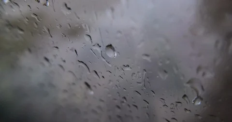 Raindrops on the glass window pane, slow zoom in. Shallow depth of field. Stock Footage 118274689