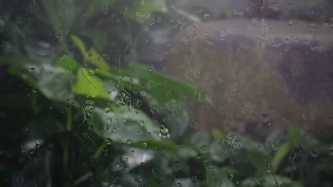 Raindrops on the glass window panes show the rain falling Stock Footage 160916903