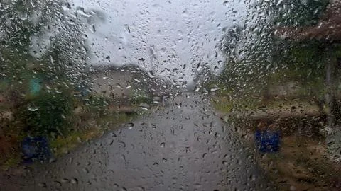 Raindrops on Glass Window View of Rainy Outdoor Street Stock Photos