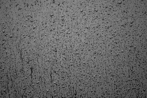 Raindrops on gloss black wall Stock Photos