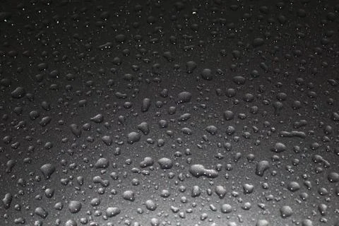 Raindrops on a grey surface Stock Photos