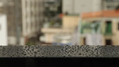 Raindrops hitting black metal railing surface Stock Footage 161865302