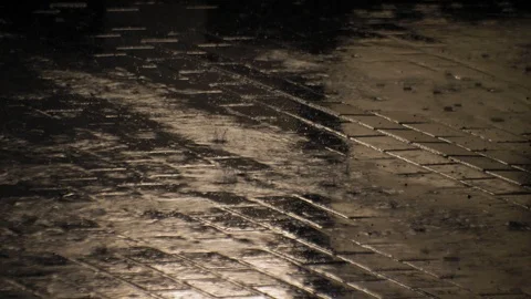 Raindrops Hitting Pavement During Heavy Rain at Night Stock Footage 111062759