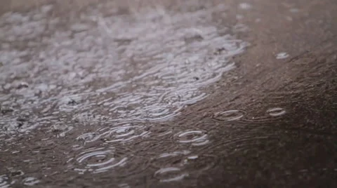 Raindrops hitting puddle Stock Footage 46805799