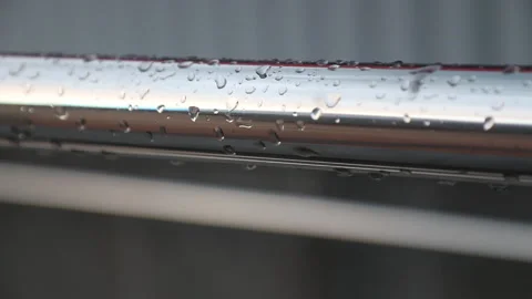 Raindrops on a metal handrail, close-up Stock Footage 134913229