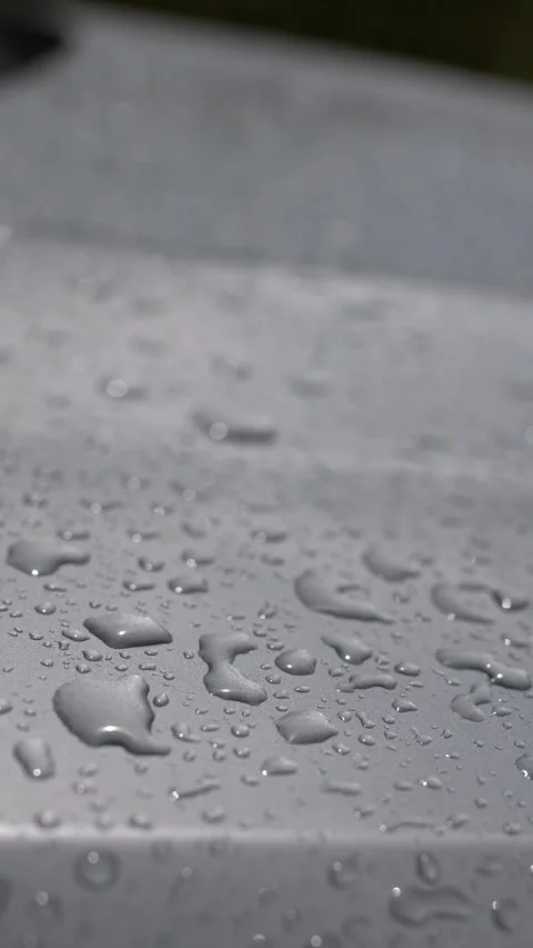 Raindrops on Metallic Silver Car Hood Surface Stock Footage 346580637