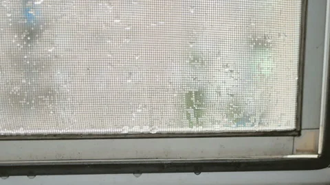Raindrops on mosquito net dirty window Stock Footage 113279643