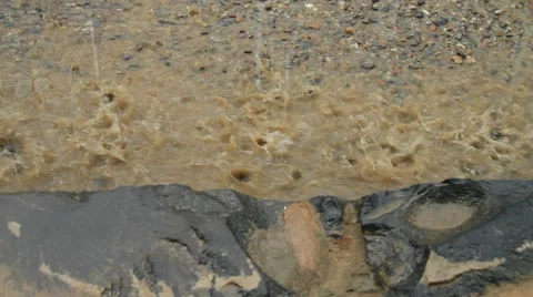 Raindrops on muddy water Stock Footage 27977287