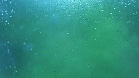 Raindrops outside the window. snow and rain outside a foggy window in autumn Stock Footage 166528704