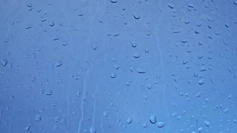 Raindrops outside the window. snow and rain outside a foggy window in autumn Stock Footage 169007171
