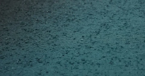 Raindrops on pavement create serene urban scene, capturing mood of Stock Footage 312002667