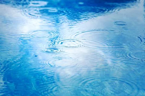 Raindrops on pool blue water surface. blue water texture as background. Stain Stock Photos