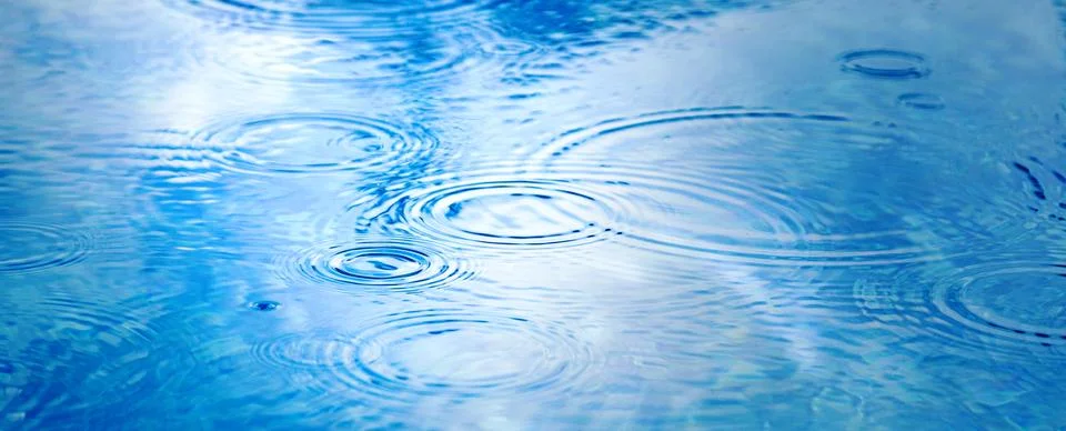 Raindrops on pool blue water surface. blue water texture as background. Stain Stock Photos