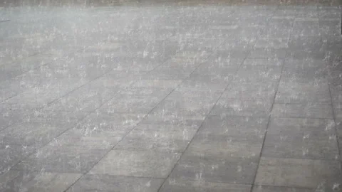Raindrops pour down an empty pavement in 4K. Video stock 166157078
