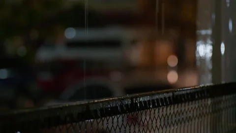 Raindrops pour down on the railing Stock Footage 227189348